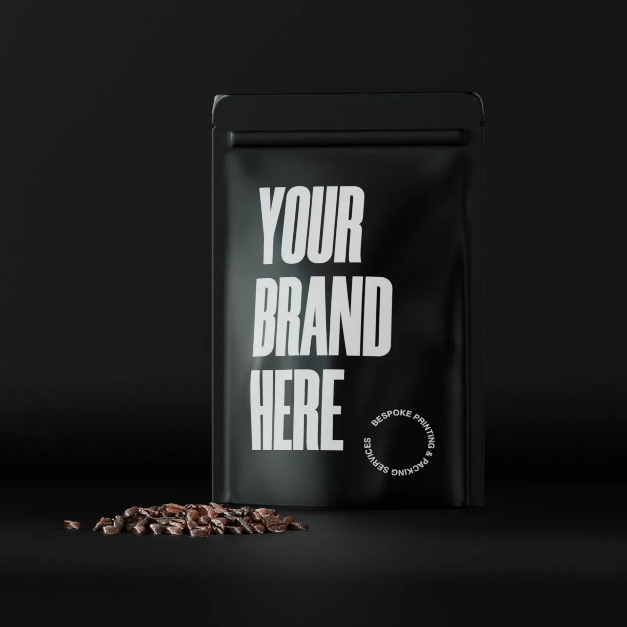 A matte black stand-up coffee pouch with white placeholder text reading YOUR BRAND HERE, ready for custom branding